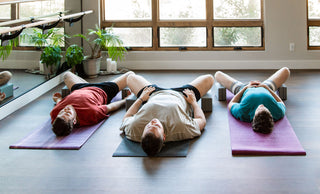 Yoga Class in Supta Baddhakonasana with Yoga Blocks
