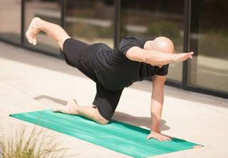 Man in Parsva Balasana (Bird Dog Pose) on Nature Ultra Mat - Evergreen