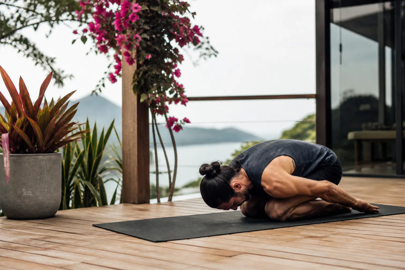 man doing rabbit in outdoor deck