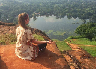 Woman Meditating on Ledge
