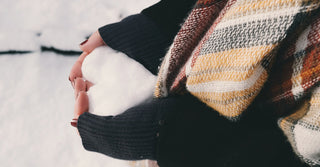 Woman Holding Heart Made of Snow