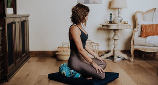 Woman sitting on Zafu Meditation Cushion - Indigo Ikat and Zabuton Pillow - Black