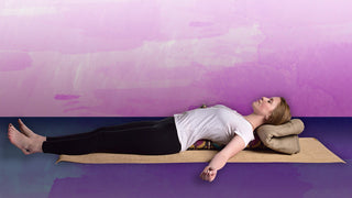 Woman Reclining on Pranayama Bolster - Bohemian Ikat on Sattva Jute Yoga Mat