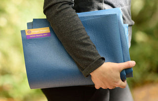 Woman Holding Tapas® Travel Yoga Mat - Blue