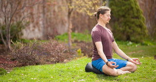 Man Meditating Outdoors on V-Shaped Meditation Cushion - Black
