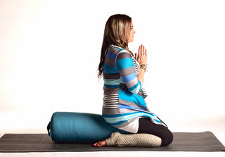 Woman in Virasana (Hero's Pose) on Round Bolster - Aqua