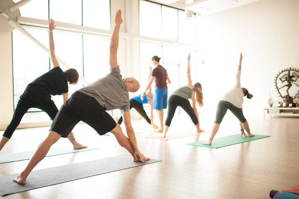 Yoga Class in Trikonasana (Triangle Pose)