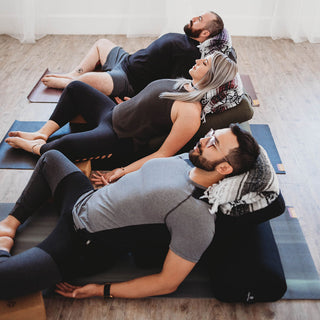 Supta Baddha Konasana with Mexican Blankets and Standard Bolsters - Gray, Burgundy, Purple