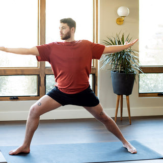 Man in Virabhadrasana II (Warrior 2) on Para Rubber XL Yoga Mat - Storm