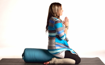 Woman in Virasana (Hero's Pose) on Round Bolster - Aqua