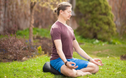 Man Sitting on V-Shaped Meditation Cushion - Black