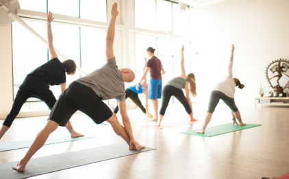 Yoga Class in Trikonasana (Triangle Pose)