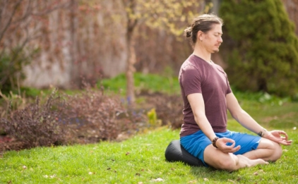 Man Meditating Outdoors on V-Shaped Meditation Cushion - Black