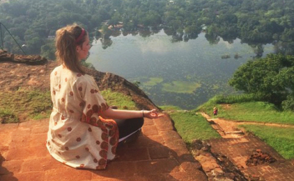 Woman Meditating on Ledge