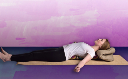 Woman Reclining on Pranayama Bolster - Bohemian Ikat on Sattva Jute Yoga Mat