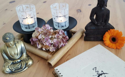 Home Yoga Space with Buddha Statues, Journal, and Candles