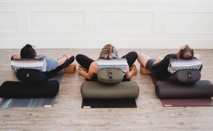 Supta Baddhakonasana on Standard Yoga Bolsters - Black, Olive, Gray