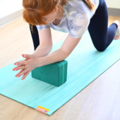 Woman in Anjaneyasana (Low Lunge) on 4 in. Foam Yoga Block - Evergreen, and Para Rubber Mat - Alpine