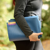 Woman Holding Tapas® Travel Yoga Mat - Blue