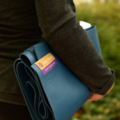 Woman Holding Tapas® Travel Yoga Mat - Blue