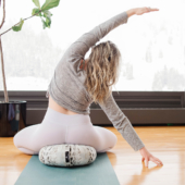 Seated Side Bend on Zafu Meditation Cushion - Wild Sky