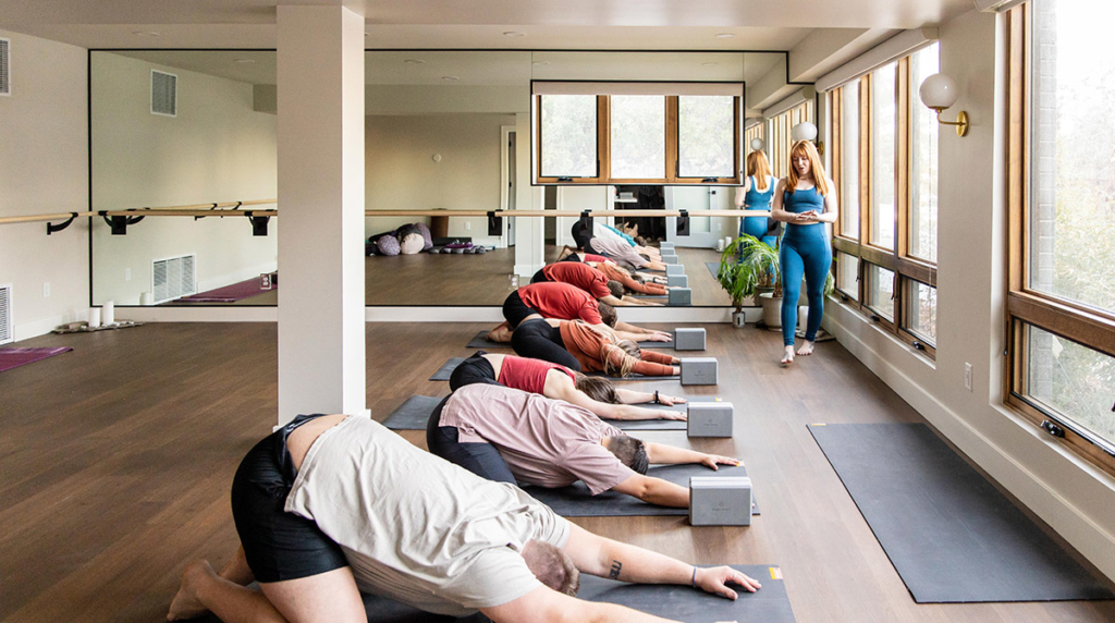 Wide Yoga Class in Balasana (Child's Pose)