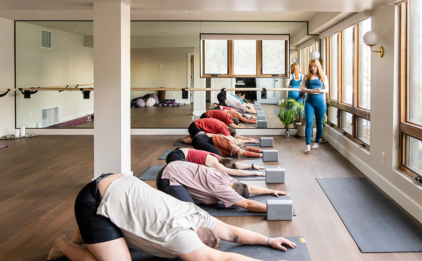 Wide Yoga Class in Balasana (Child's Pose)