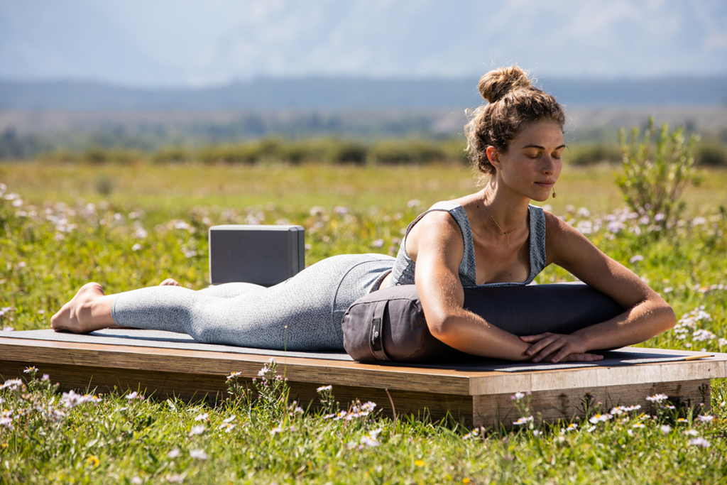 Woman in Sphinx Pose on Standard Bolster - Gray