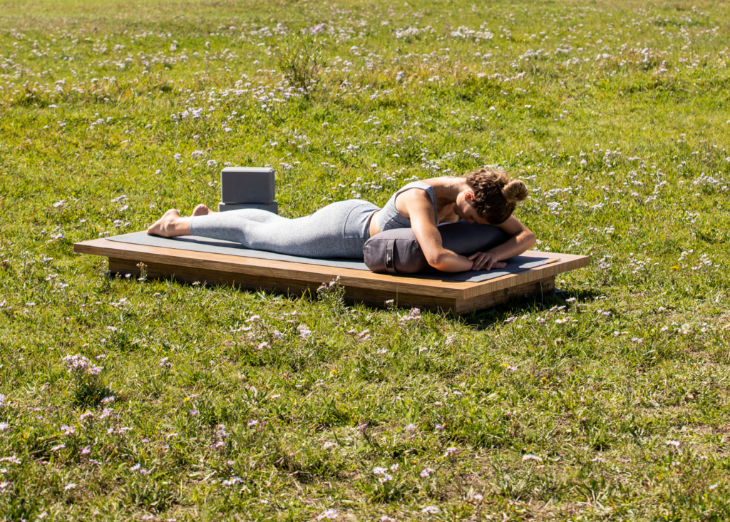 Woman in Sphinx Pose on Standard Bolster - Gray