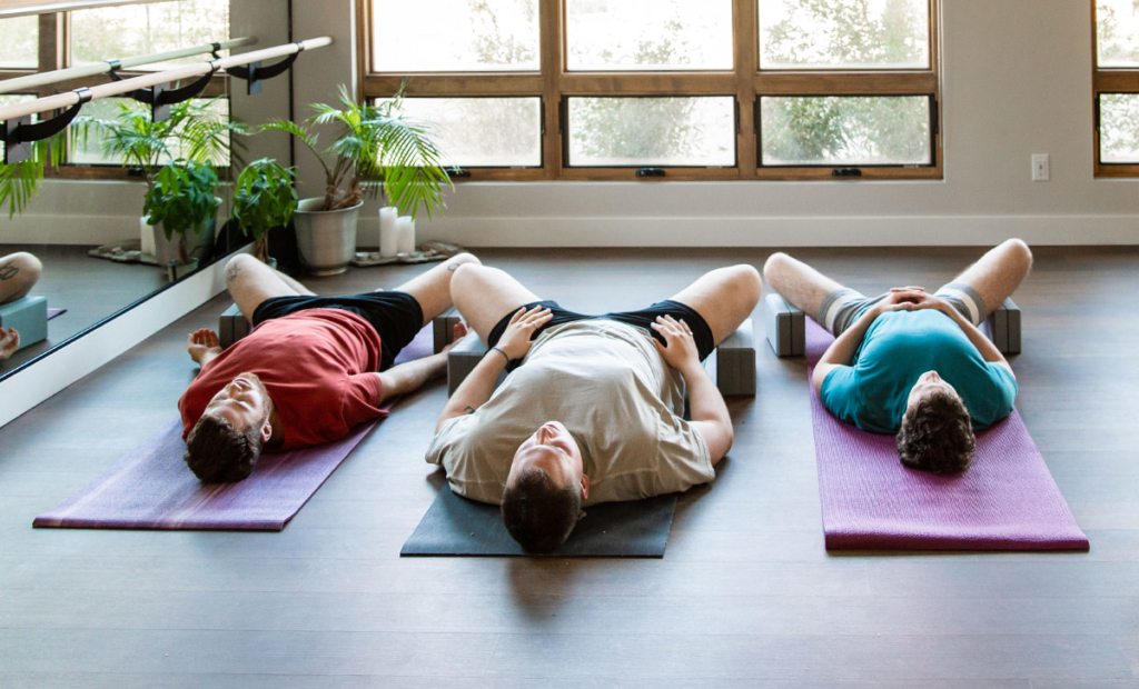 Yoga Class in Supta Baddhakonasana with Yoga Blocks