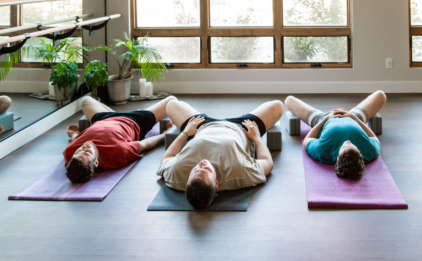 Yoga Class in Supta Baddhakonasana with Yoga Blocks