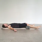 Man Reclining with EZ Clean Junior Yoga Bolster - Charcoal Under Knees