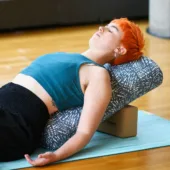 Person Reclining on Standard Yoga Bolster - Misty Palms, Cork Blocks