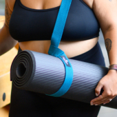 Woman Carrying Ultimate Cushion Mat with Strap Sling Yoga Mat Carrier - Peacock
