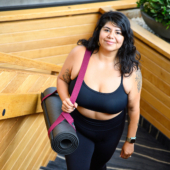 Woman Carrying Ultimate Cushion Mat with Strap Sling Yoga Mat Carrier - Raspberry